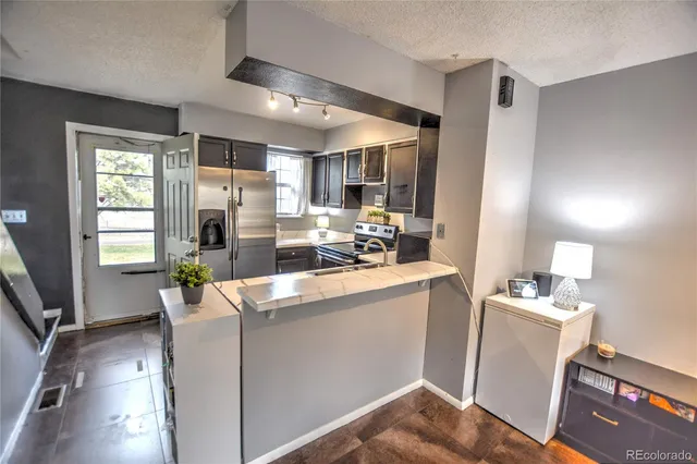 a kitchen with a sink appliances and cabinets