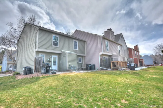 a view of a house with a yard and sitting area