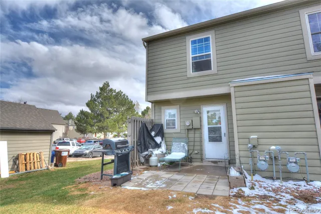 a view of a house with backyard porch and sitting area