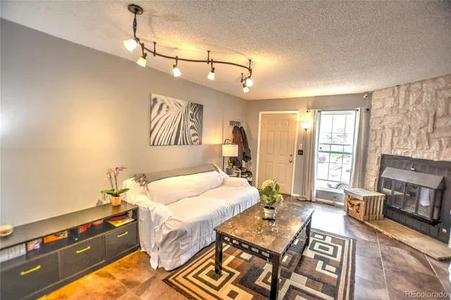 a spacious bedroom with a bed and a tv