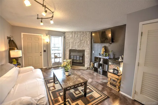 a living room with furniture and a fireplace