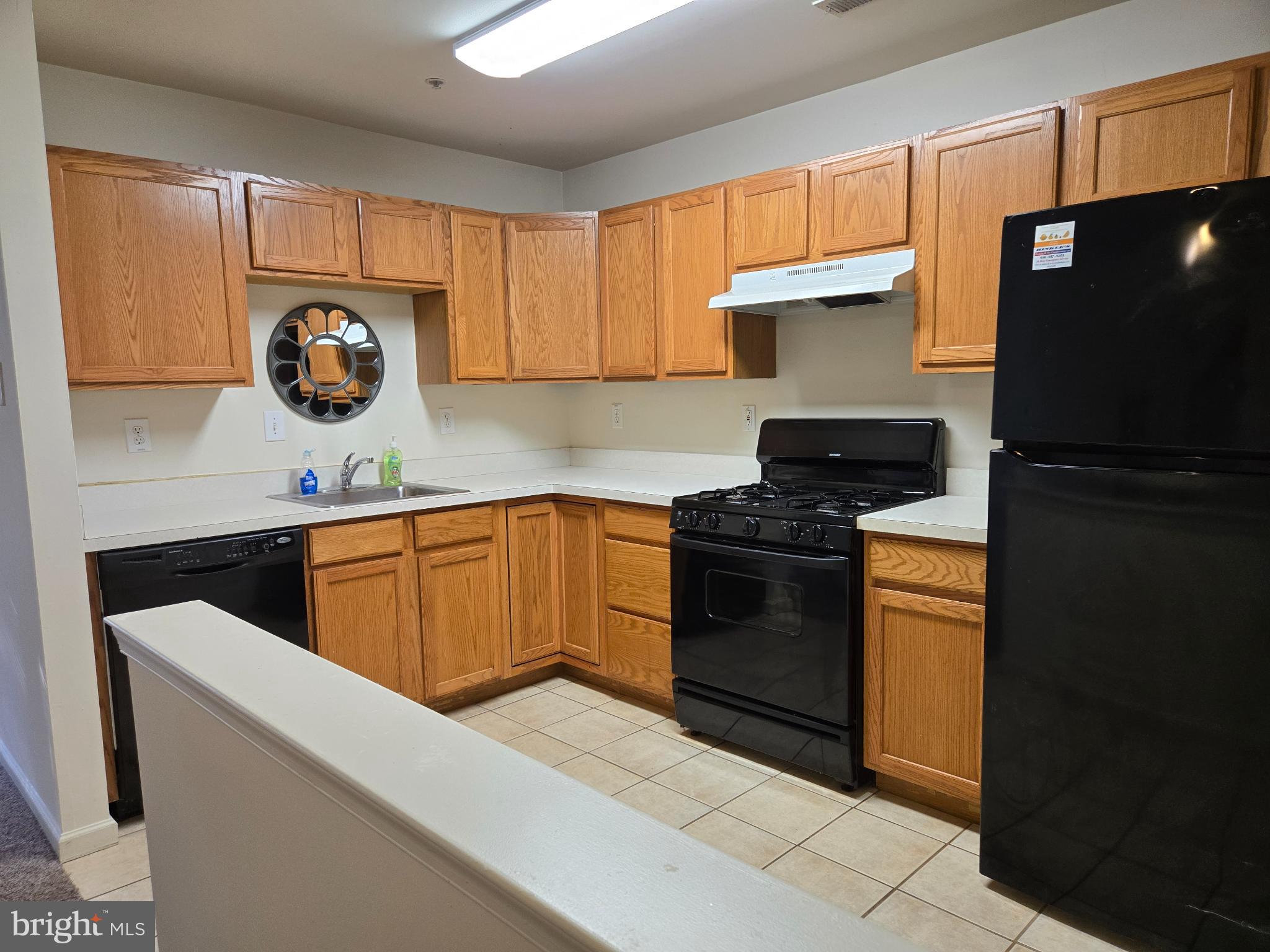 1302 Black Walnut Drive, Unit 1302 Phoenixville, PA 19460 - Photo 5 of 11 Modern kitchen with warm wood cabinetry.