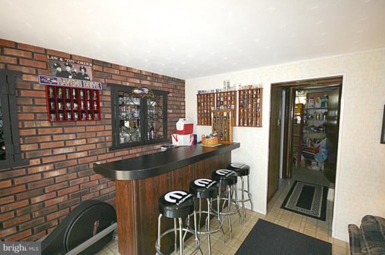 497 St Barbara Lane Odenton, MD 21113 - Photo 11 of 25 a kitchen with a sink and chairs