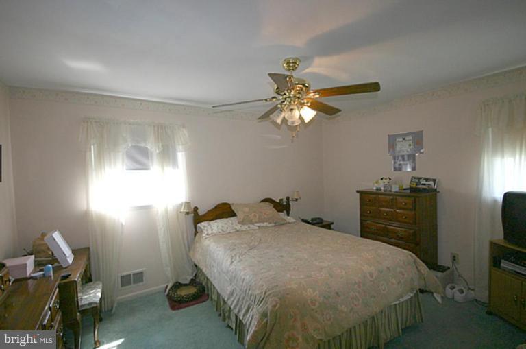 497 St Barbara Lane Odenton, MD 21113 - Photo 12 of 25 a bedroom with a bed and a chandelier