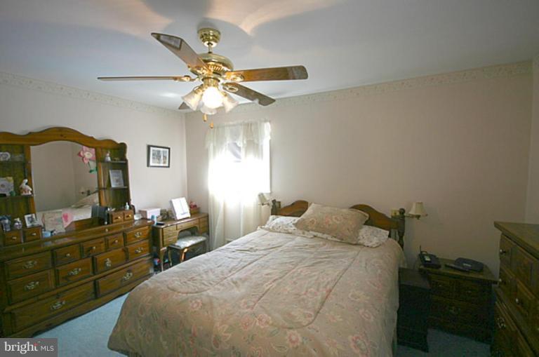497 St Barbara Lane Odenton, MD 21113 - Photo 13 of 25 a bedroom with a bed and a chandelier