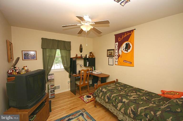 497 St Barbara Lane Odenton, MD 21113 - Photo 14 of 25 a bed room with a bed mirror and a window