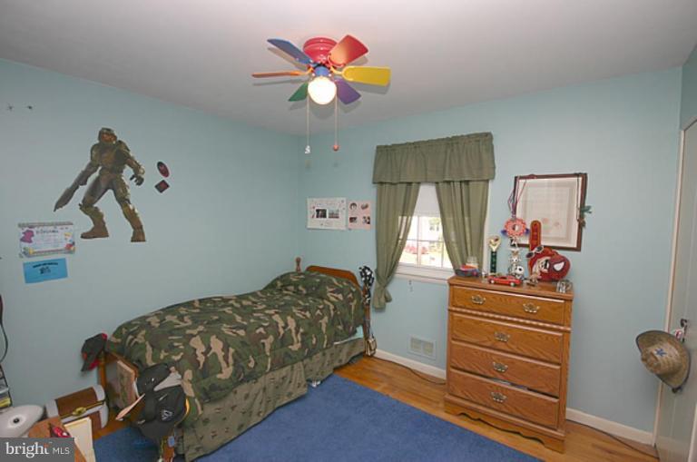 497 St Barbara Lane Odenton, MD 21113 - Photo 15 of 25 a bedroom with a bed and a chandelier