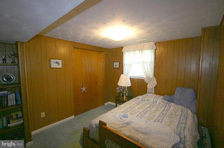 497 St Barbara Lane Odenton, MD 21113 - Photo 17 of 25 a bedroom with a bed and a chandelier