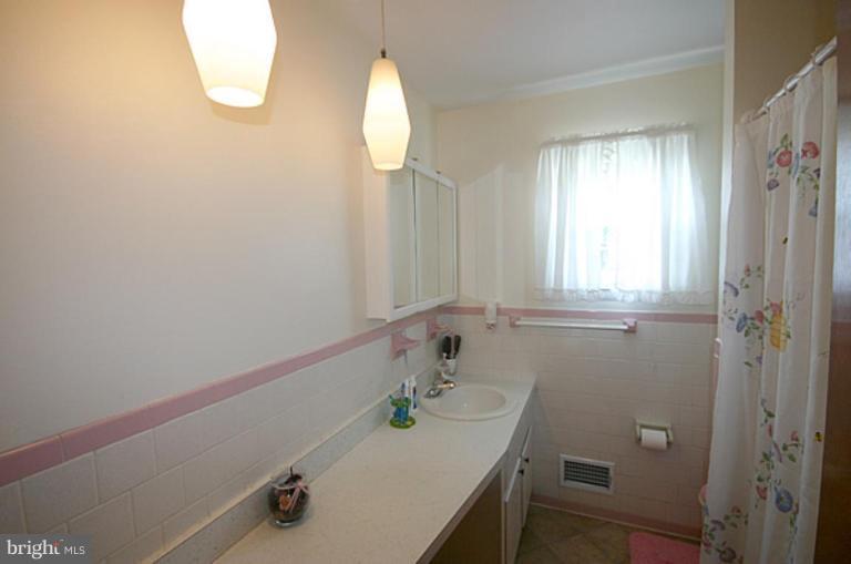 497 St Barbara Lane Odenton, MD 21113 - Photo 19 of 25 a bathroom with a sink and a window