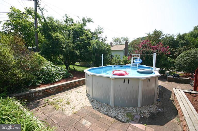 497 St Barbara Lane Odenton, MD 21113 - Photo 22 of 25 a view of a swimming pool with a patio