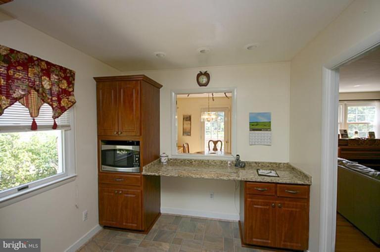 497 St Barbara Lane Odenton, MD 21113 - Photo 4 of 25 a kitchen with granite countertop a stove and a sink
