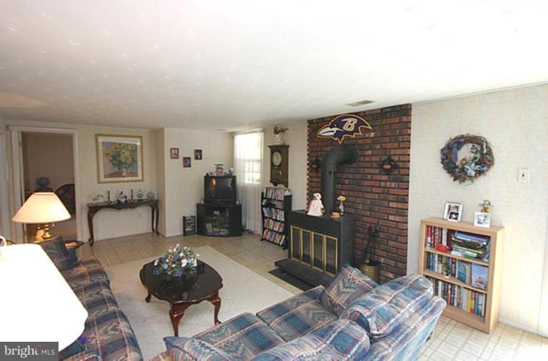 497 St Barbara Lane Odenton, MD 21113 - Photo 10 of 25 a living room with furniture and a rug