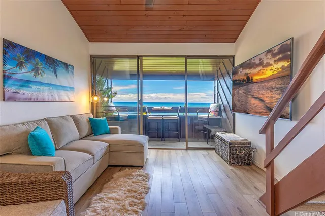 a living room with furniture and a floor to ceiling window