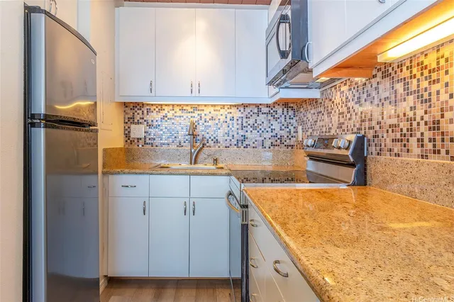 a view of a kitchen with a sink and wooden floor