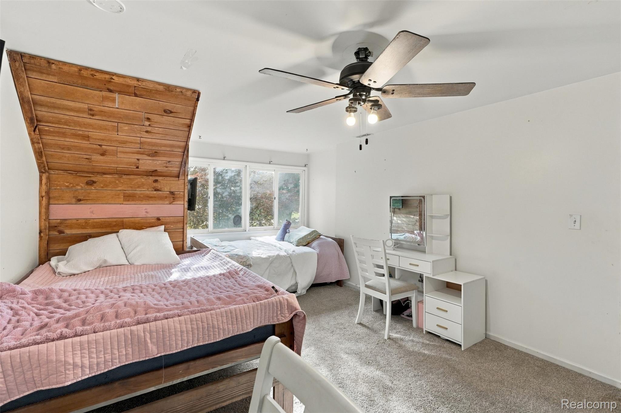 26516 Romine Road New Boston, MI 48164 - Photo 29 of 62 Bright room featuring ample natural light, a ceiling fan with integrated lighting, and neutral carpeting