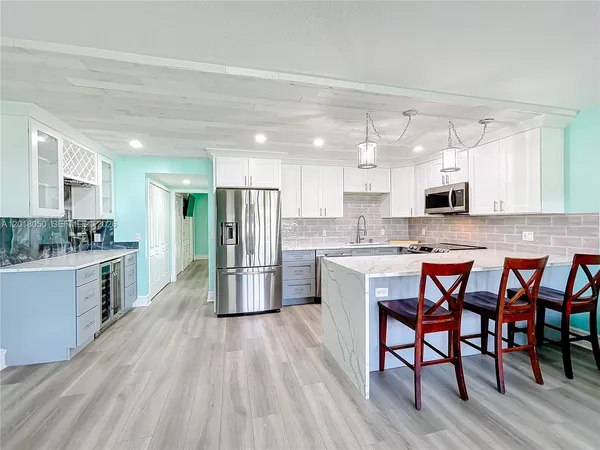 a large kitchen with a table and chairs in it