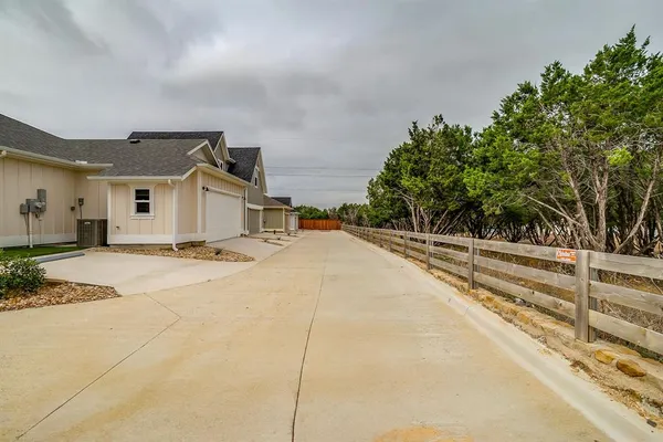 a view of house with yard and basketball ground
