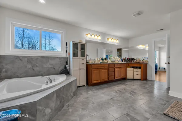 a large white kitchen with a large window