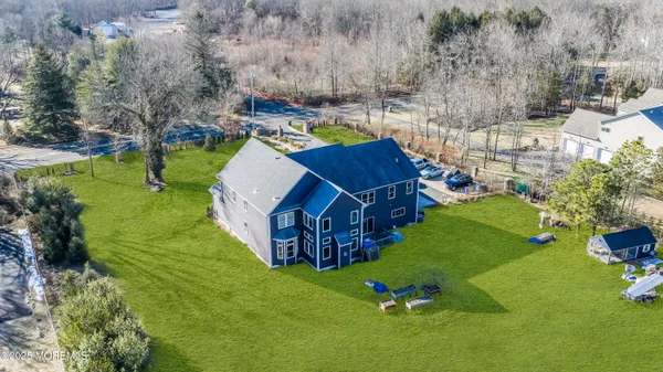 an aerial view of a house with garden space and street view