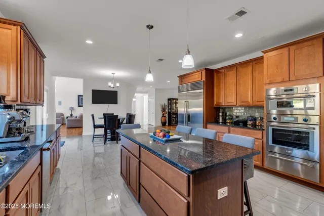 a view of a hallway with wooden floor and windows