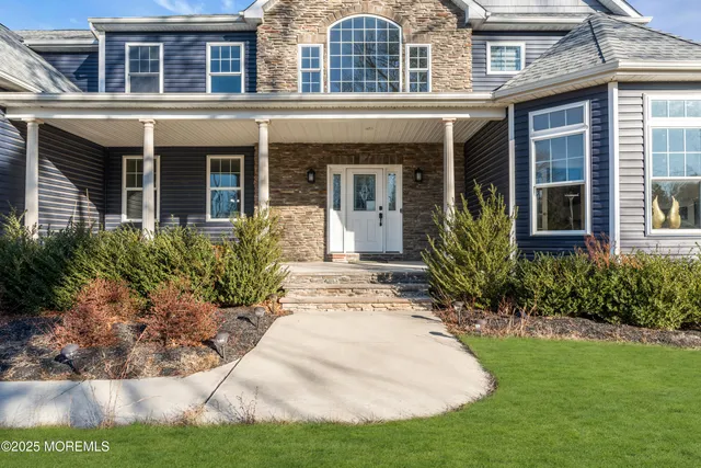 front view of a brick house with a yard