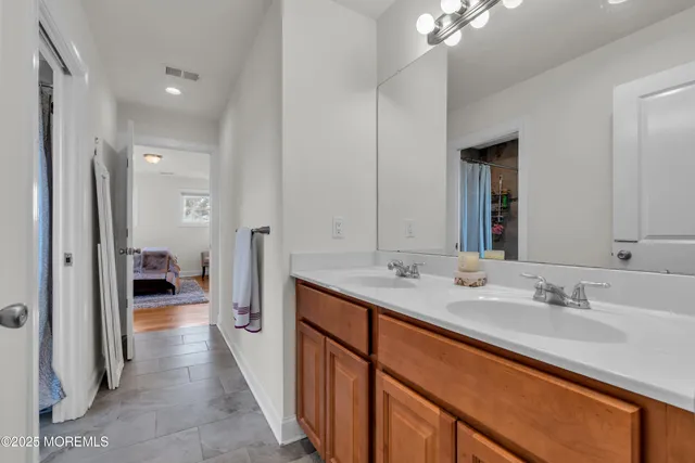 a bathroom with a sink a toilet and mirror