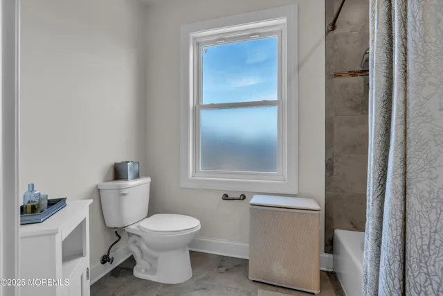 a living room with furniture and a book shelf