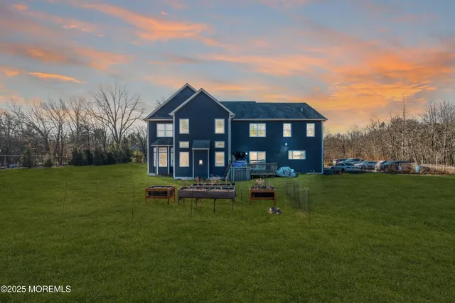 an aerial view of a house with garden space and street view