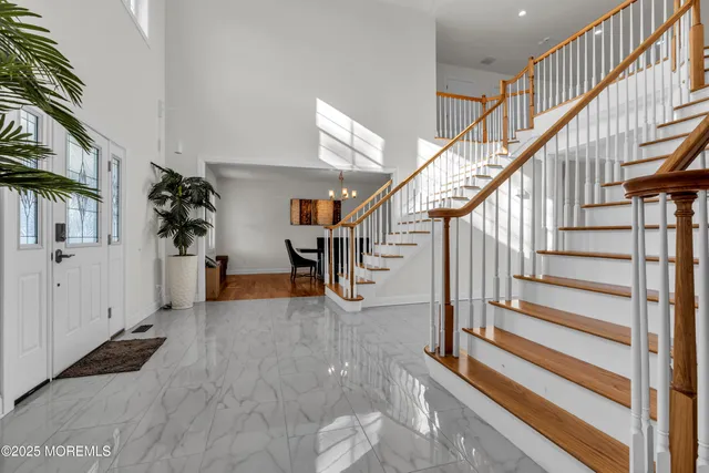 a view of a dining room with furniture a chandelier and wooden floor