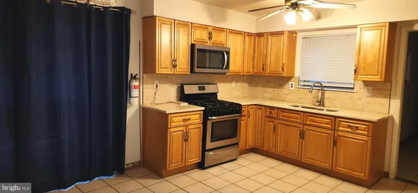 a kitchen with stainless steel appliances granite countertop a sink and a refrigerator