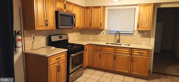 a kitchen with stainless steel appliances granite countertop a sink stove and microwave