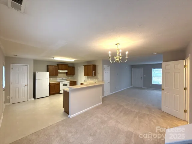 a view of a kitchen with a sink and a refrigerator