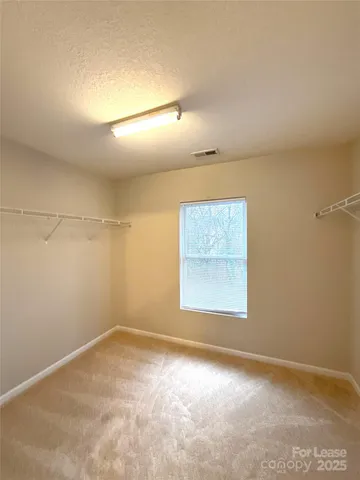 an empty room with a empty space and windows