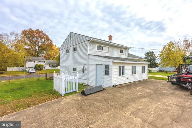 a view of a house with a yard and sitting area