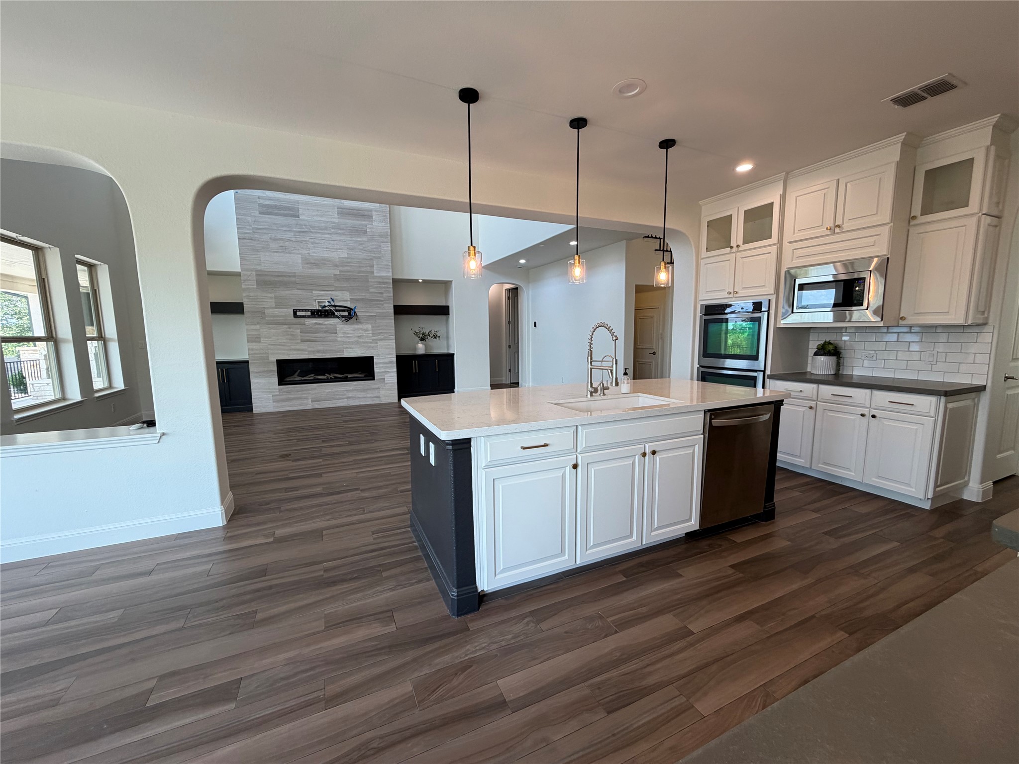 7801 Aria Loop Austin, TX 78736 - Photo 9 of 40 Expansive Kitchen with White Cabinets, Gold hardware & Glass front Upper Cabinets