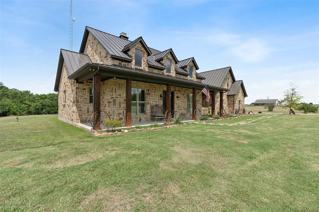 4180 North Smith Road Fate, TX 75087 - Photo 3 of 27 a view of a house with a backyard porch and garden