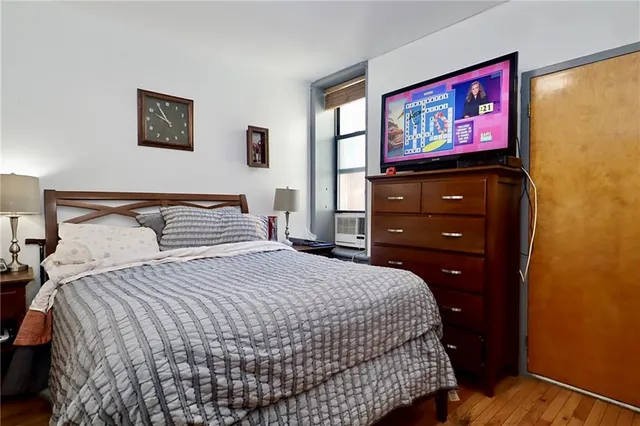 a bedroom with a bed and a dresser