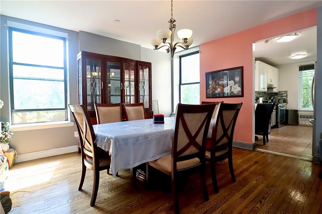 848 Park Place, Unit 4E Brooklyn, NY 11216 - Photo 6 of 22 a view of a dining room with furniture a chandelier and wooden floor
