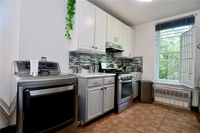 a kitchen with a stove microwave and cabinets