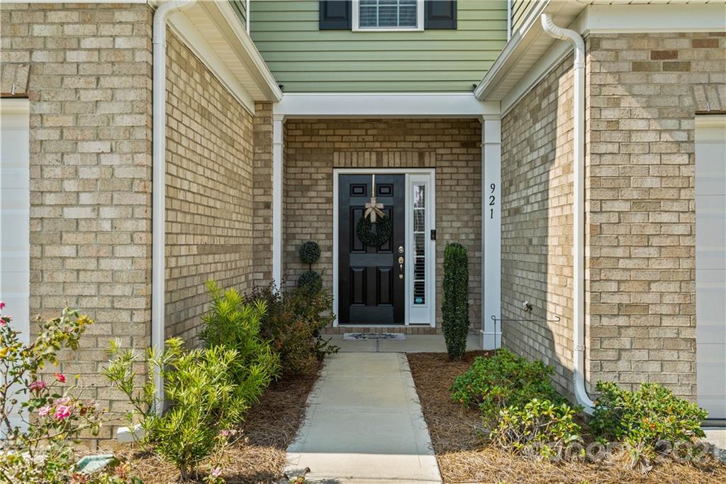 921 Wicawa Road, Unit 309 Fort Mill, SC 29708 - Photo 2 of 28 a stone house with potted plants in front of door