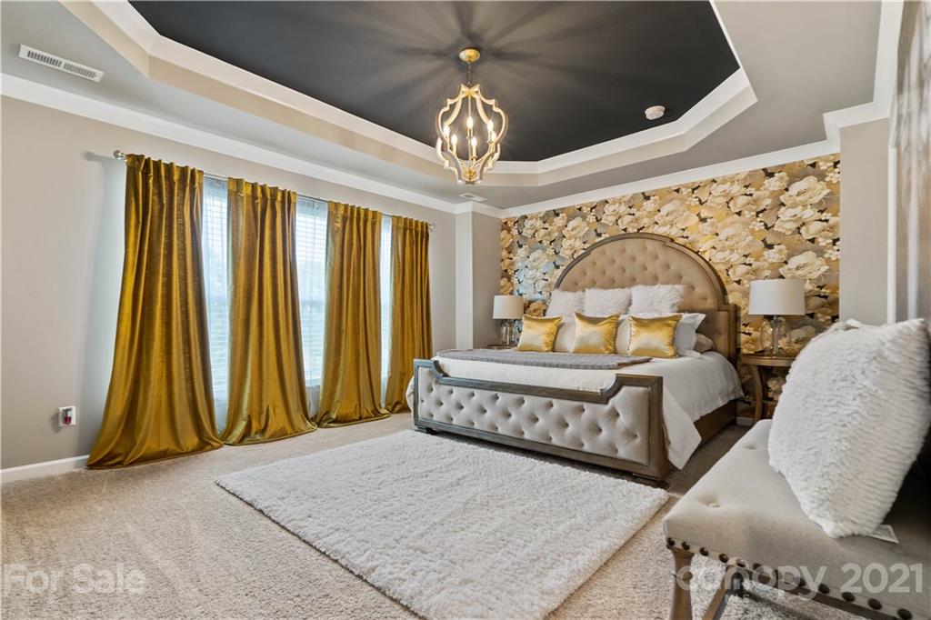 921 Wicawa Road, Unit 309 Fort Mill, SC 29708 - Photo 14 of 28 a bed room with a bed and a chandelier