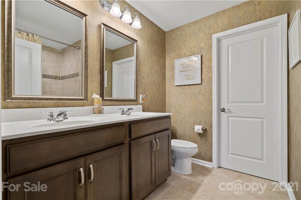 921 Wicawa Road, Unit 309 Fort Mill, SC 29708 - Photo 16 of 28 a bathroom with a double vanity sink toilet and a mirror