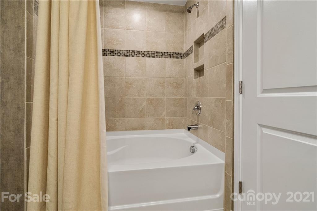 921 Wicawa Road, Unit 309 Fort Mill, SC 29708 - Photo 17 of 28 a bathroom with bathtub and a shower