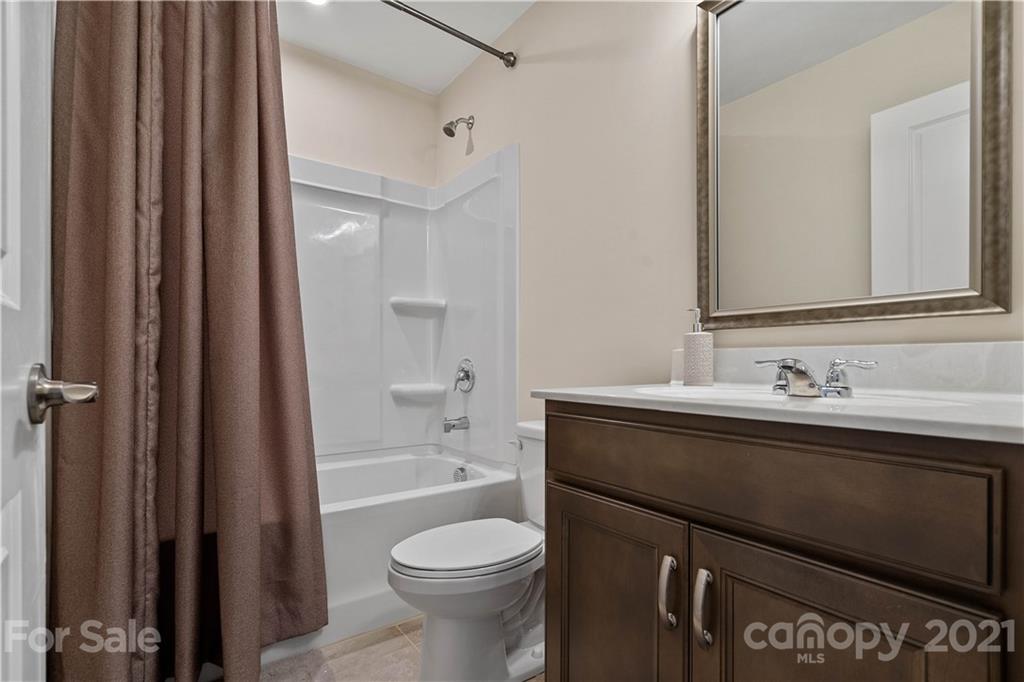 921 Wicawa Road, Unit 309 Fort Mill, SC 29708 - Photo 23 of 28 a bathroom with a sink a toilet and shower