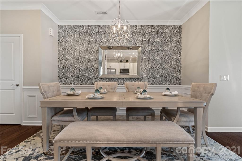 921 Wicawa Road, Unit 309 Fort Mill, SC 29708 - Photo 4 of 28 a view of a dining room with furniture and wooden floor