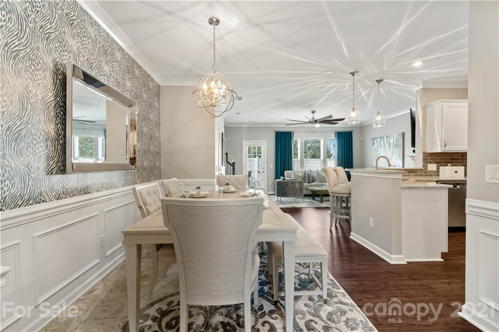 921 Wicawa Road, Unit 309 Fort Mill, SC 29708 - Photo 5 of 28 a view of a dining room and livingroom with furniture wooden floor a chandelier