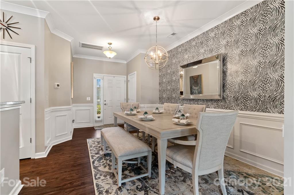 921 Wicawa Road, Unit 309 Fort Mill, SC 29708 - Photo 6 of 28 a view of a dining room with furniture and wooden floor