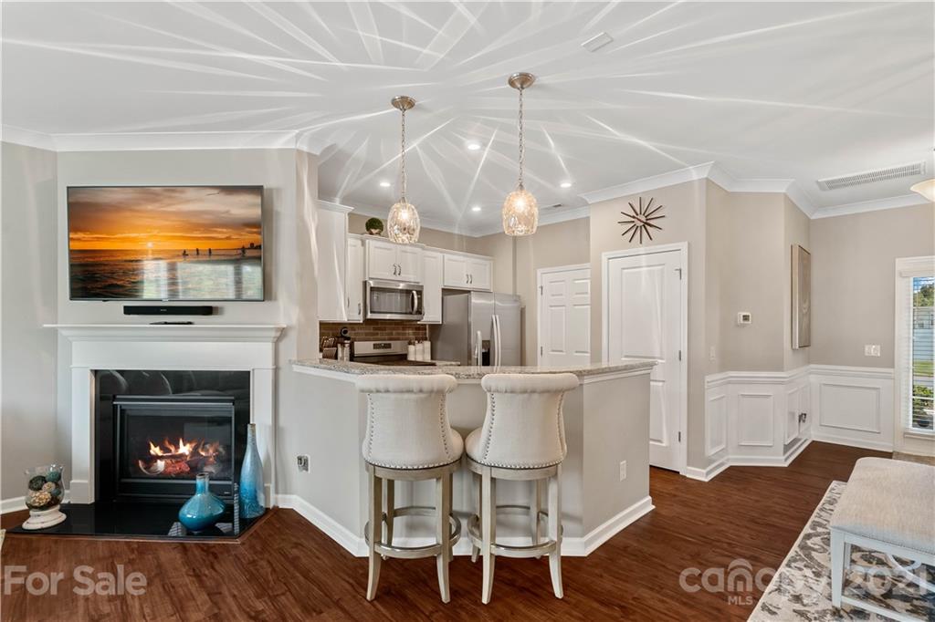 921 Wicawa Road, Unit 309 Fort Mill, SC 29708 - Photo 7 of 28 a living room with furniture a fireplace and a flat screen tv