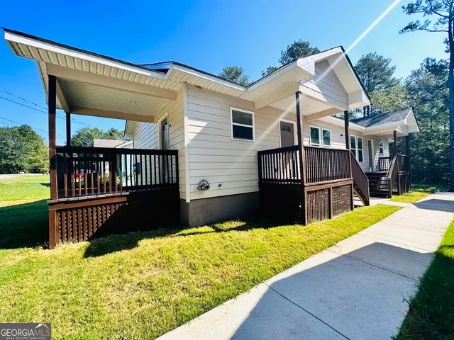 a view of a house with a wooden fence