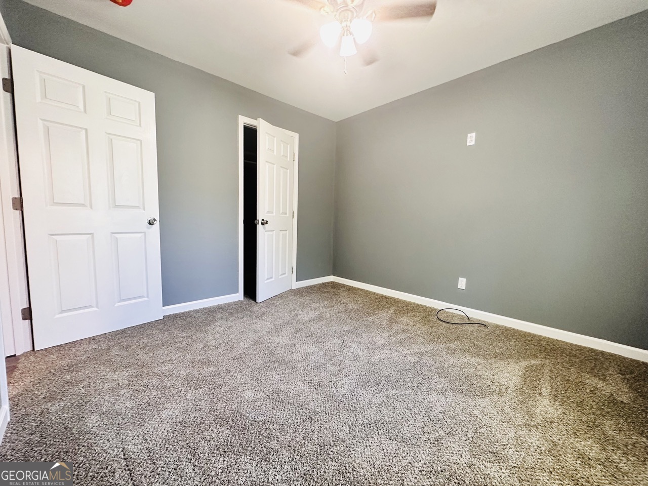 459 Merrywood Drive, Unit B LaGrange, GA 30241 - Photo 13 of 15 an empty room with a chandelier fan